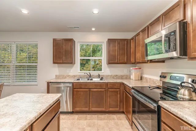 a kitchen with a sink stove and cabinets