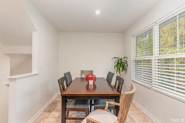 a living room with furniture a flat screen tv and a window