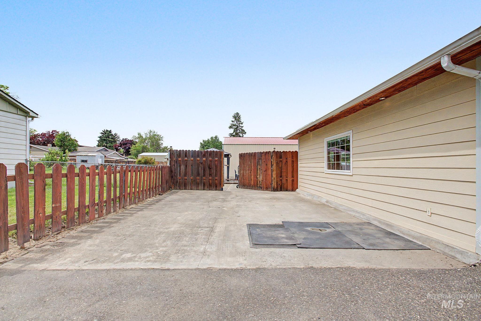 3314 6th Street Lewiston, ID 83501 - Photo 50 of 50 Concrete patio area with a wood picket fence and a horizontal siding exterior