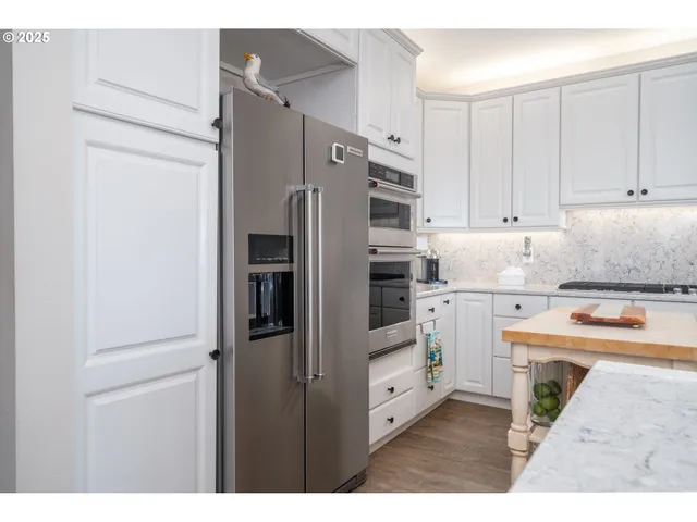 a living room with furniture a rug and a bookshelf