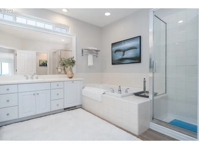 a bedroom with a bed a mirror and lamp