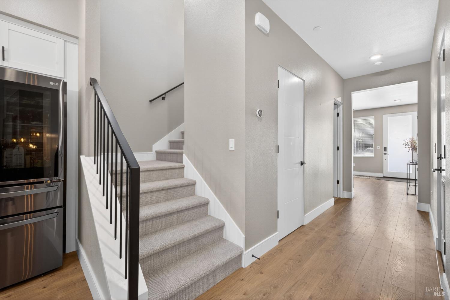 2215-2217 Versaro Drive Santa Rosa, CA 95403 - Photo 19 of 45 a view of a hallway with wooden floor and staircase