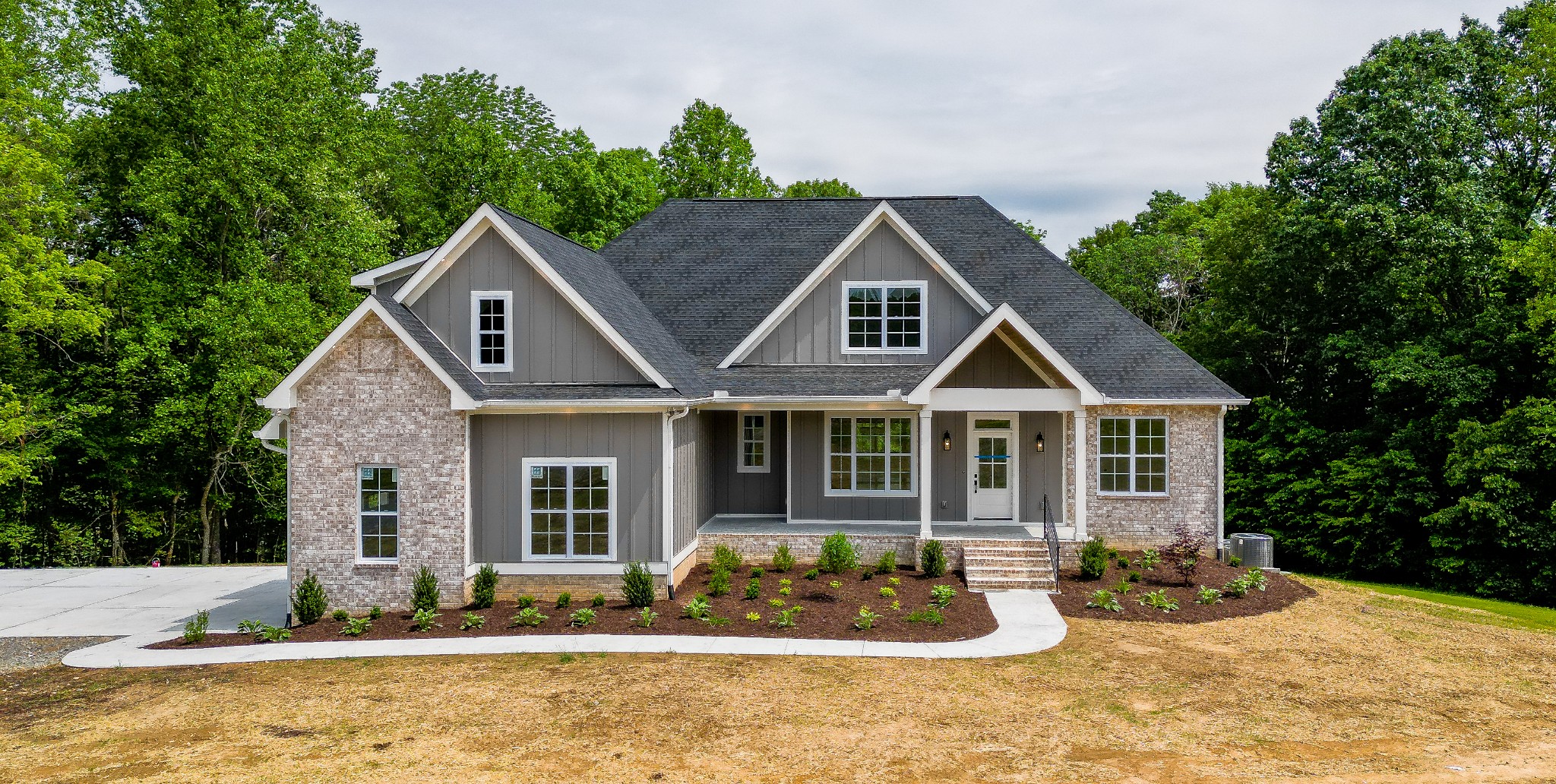 7035 Hall Road Greenbrier, TN 37073 - Photo 1 of 57 a front view of a house with a yard outdoor seating and covered with trees