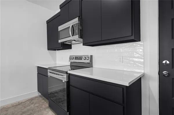 a kitchen with a sink and a microwave