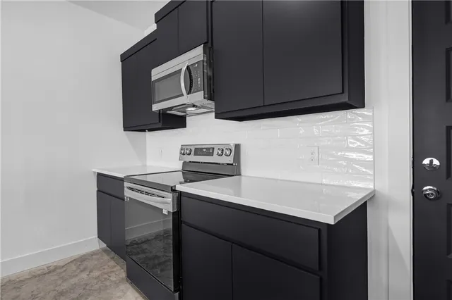 a kitchen with a sink and a microwave