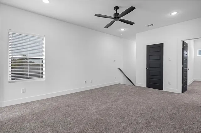 a view of a livingroom with a ceiling fan and window