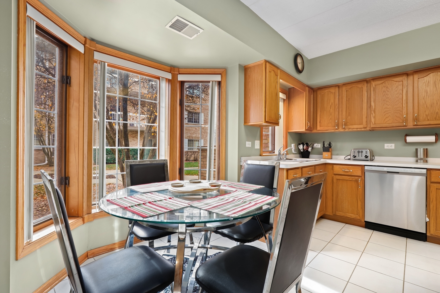 7825 Bristol Park Drive, Unit 1C Tinley Park, IL 60477 - Photo 11 of 22 a kitchen with a wooden table and chairs