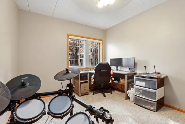 a view of a workspace with furniture and a window
