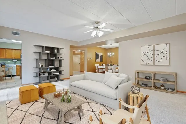 a living room with furniture and a chandelier