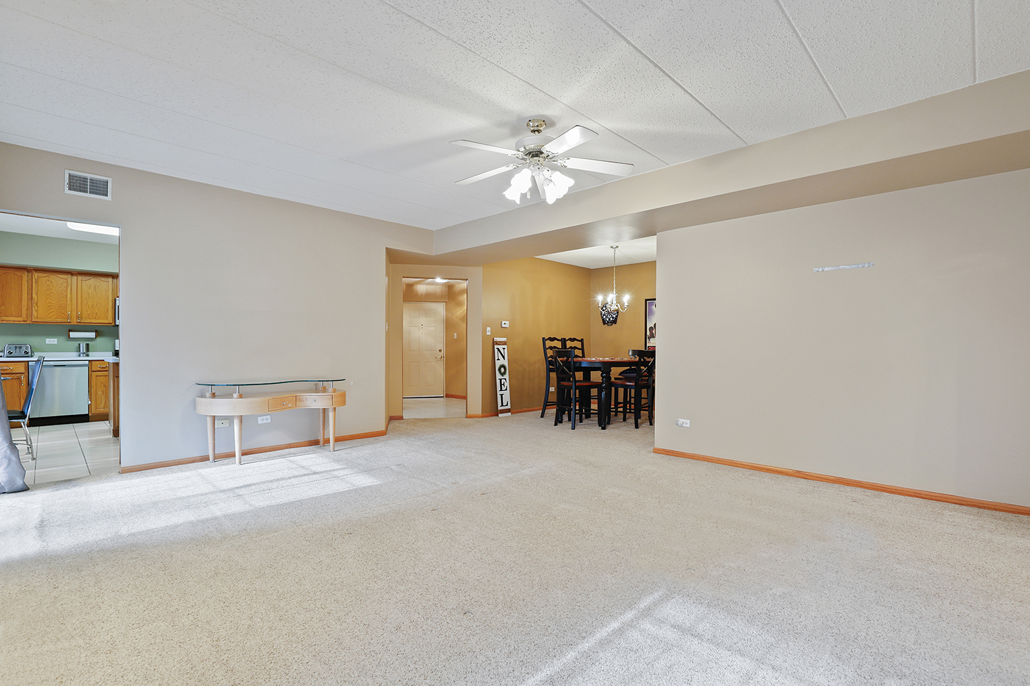 7825 Bristol Park Drive, Unit 1C Tinley Park, IL 60477 - Photo 6 of 22 an empty room with chandelier fan and windows