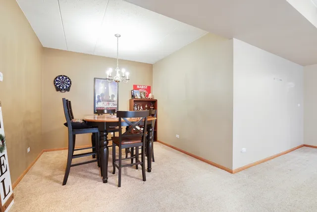 a view of a dining room with furniture and chandelier