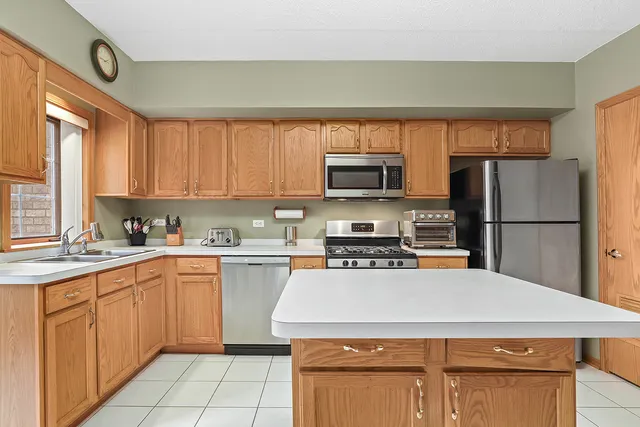 a kitchen with a stove a sink and a refrigerator