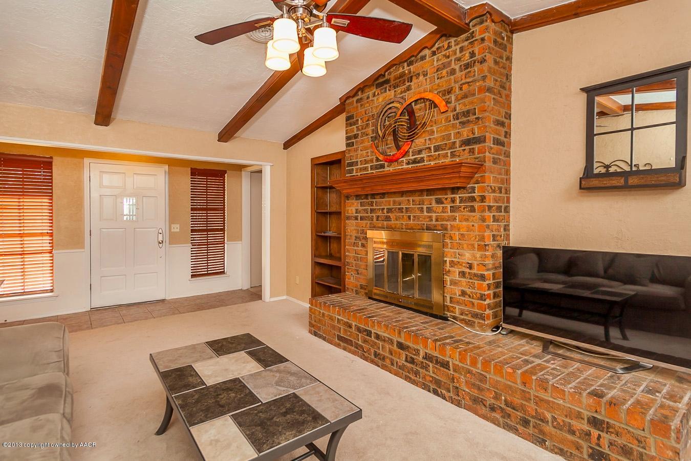5300 South Milam Street Amarillo, TX 79110 - Photo 3 of 21 a living room with furniture and a fireplace