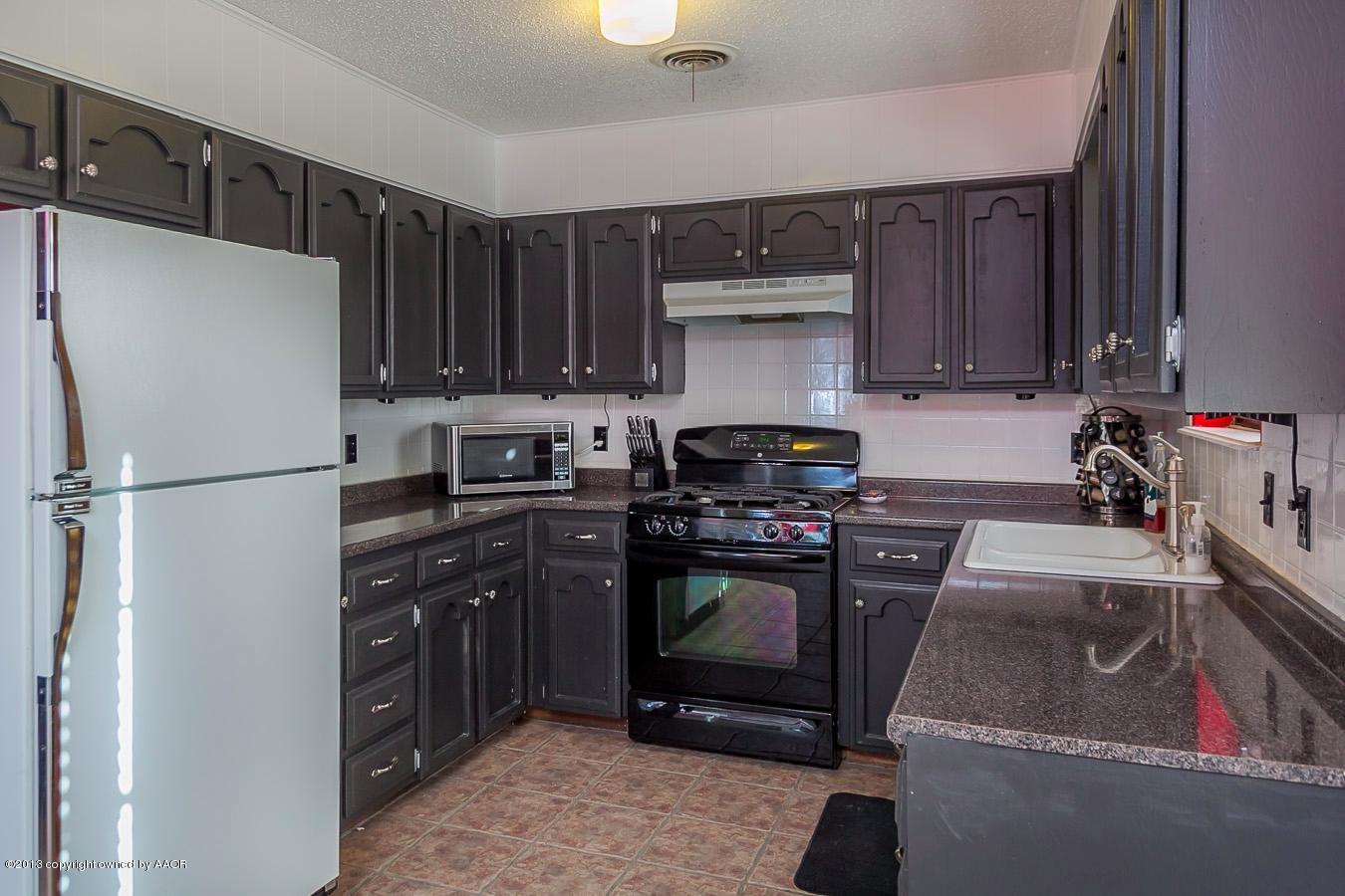 5300 South Milam Street Amarillo, TX 79110 - Photo 8 of 21 a kitchen with stainless steel appliances granite countertop a refrigerator stove and sink