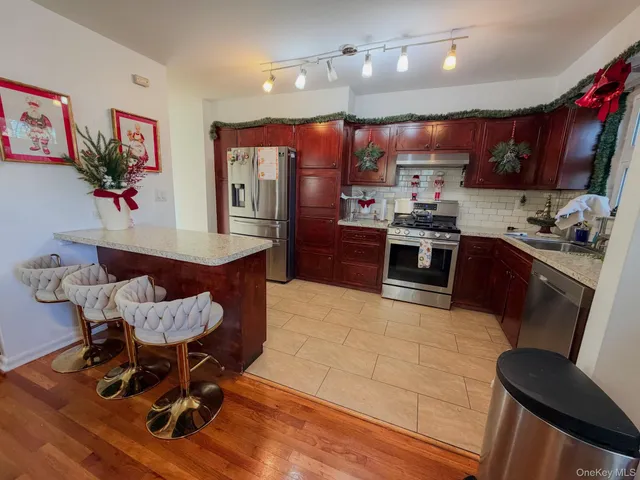 a kitchen with cabinets and wooden floor