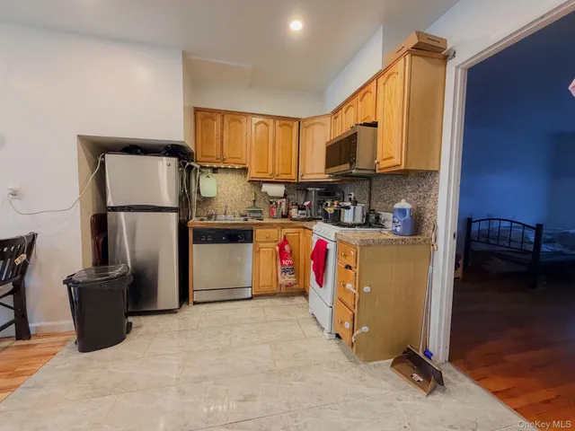 a kitchen with stainless steel appliances granite countertop a refrigerator sink and cabinets