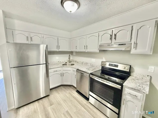 a bathroom with a sink mirror vanity and toilet