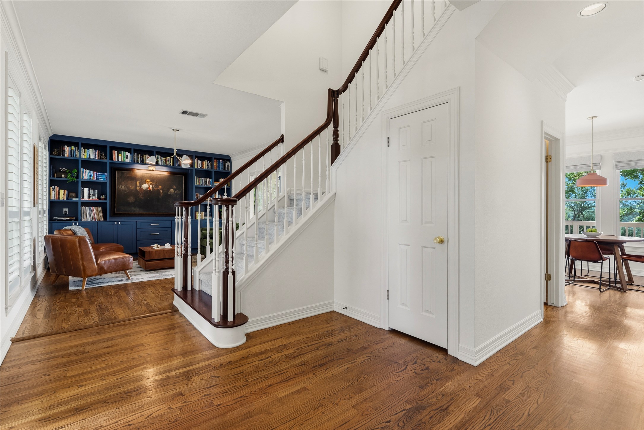 3107 Lookout Lane Austin, TX 78746 - Photo 8 of 39 Rich hardwood floors welcome you, leading past a grand staircase and a built-in library with tailored shelving.