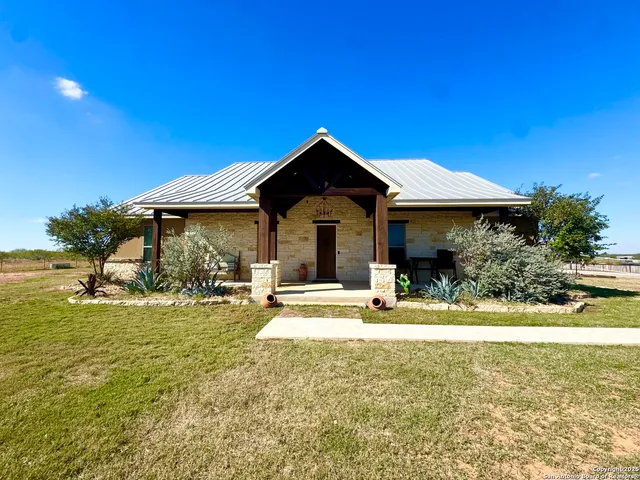 a view of a house with swimming pool and sitting area