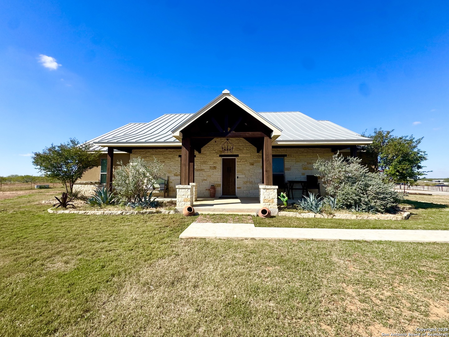 a view of a house with swimming pool and sitting area