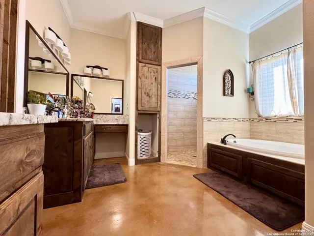 a bathroom with a tub sink and mirror