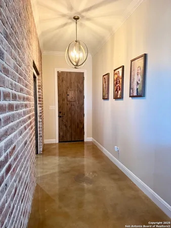 a view of an empty room with a chandelier