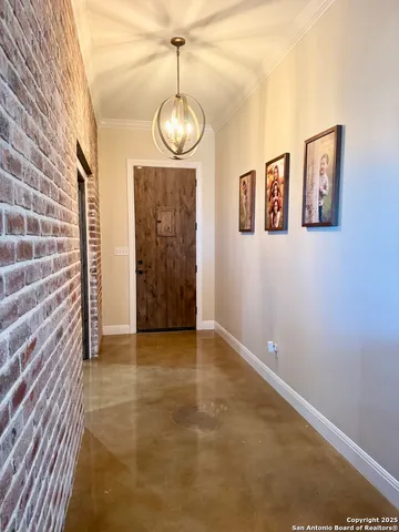 a view of an empty room with a chandelier