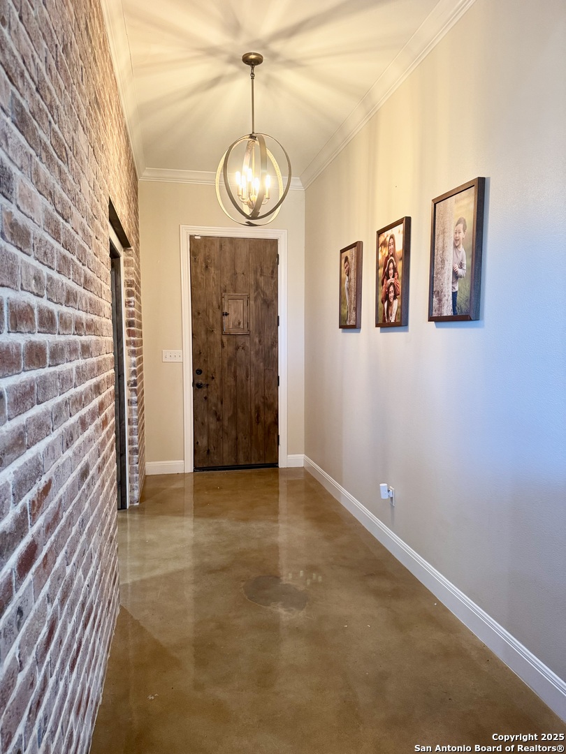 16489 Farm To Market Road 472 Devine, TX 78016 - Photo 16 of 31 a view of an empty room with a chandelier