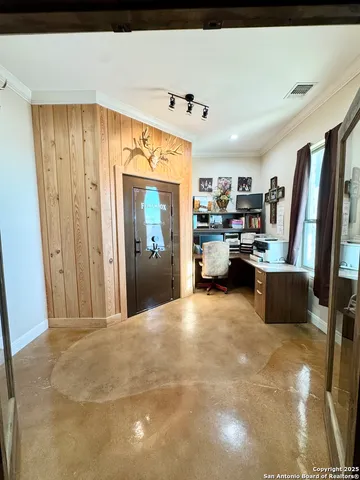 a view of a kitchen with kitchen island granite countertop a refrigerator and a sink