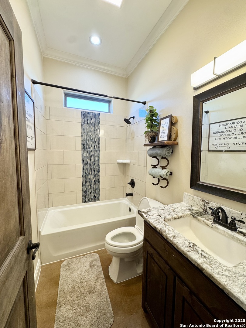 16489 Farm To Market Road 472 Devine, TX 78016 - Photo 18 of 31 a bathroom with a granite countertop sink toilet and shower
