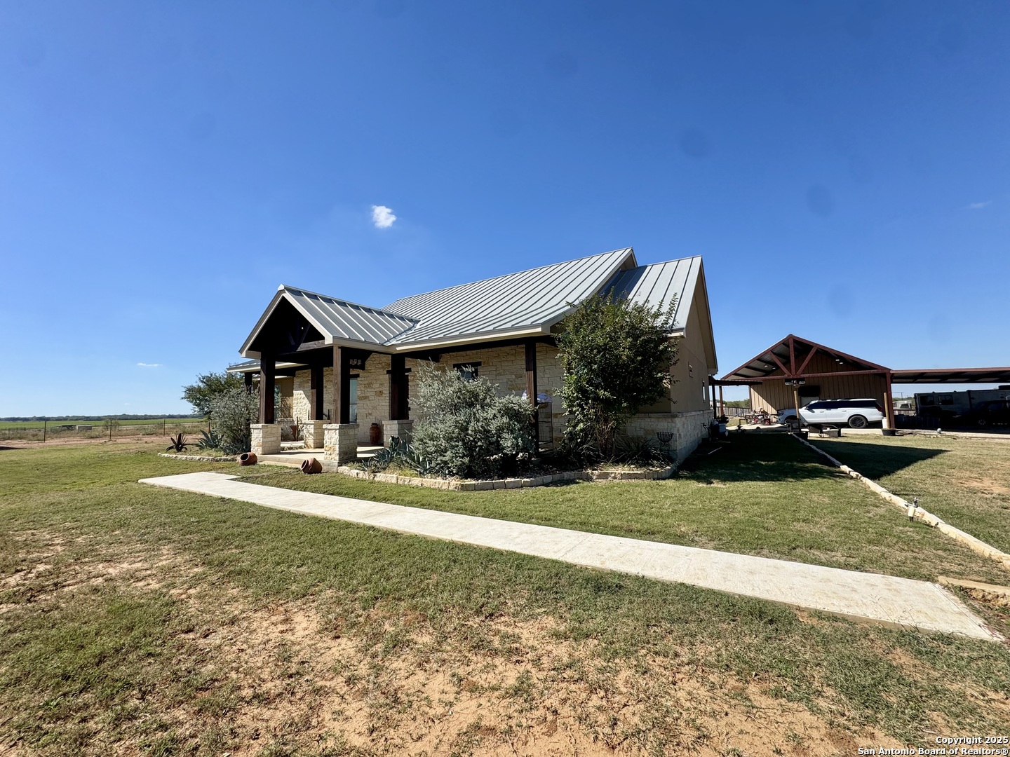 16489 Farm To Market Road 472 Devine, TX 78016 - Photo 2 of 31 a front view of a house with a yard