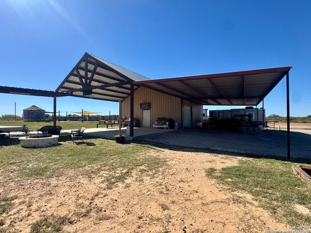 a view of a house with backyard porch and sitting area