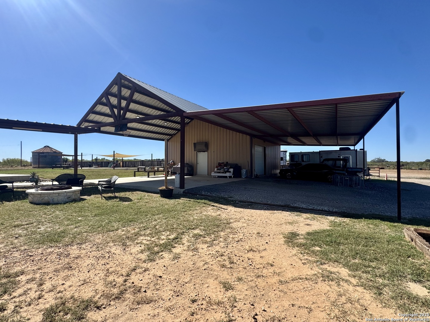 16489 Farm To Market Road 472 Devine, TX 78016 - Photo 24 of 31 a view of a house with backyard porch and sitting area