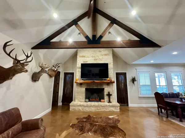 a living room with furniture a flat screen tv and a fireplace