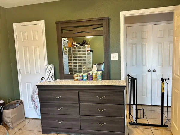 a bathroom with a granite countertop sink a mirror and a shower