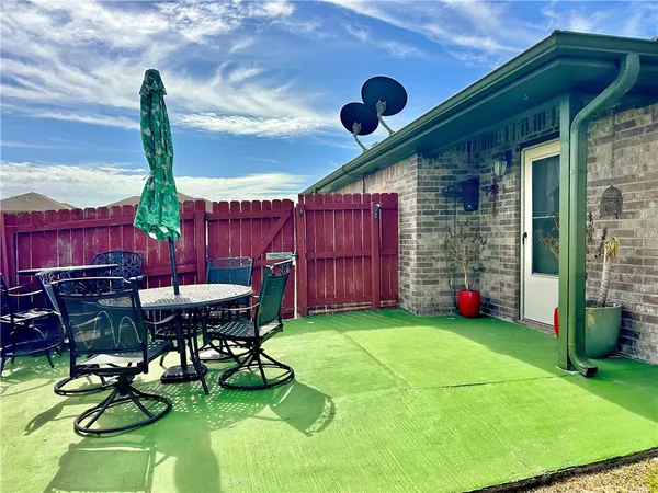 a view of a chairs and table in backyard