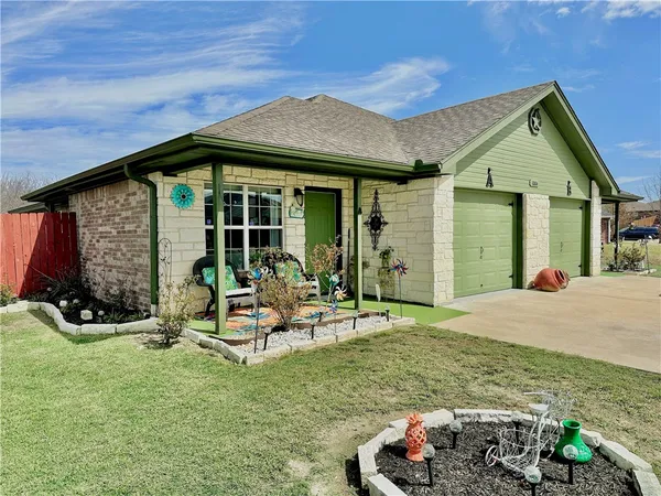 a front view of a house with garden