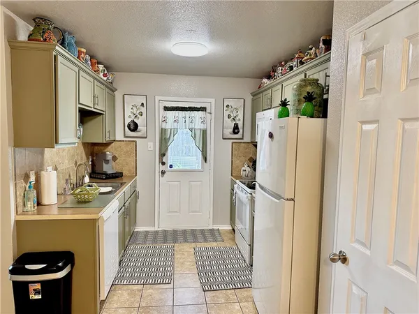 a kitchen with a refrigerator a stove a washer and dryer