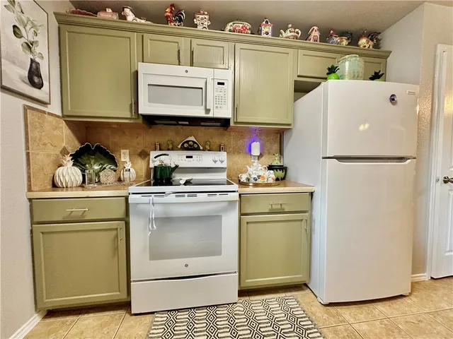 a white refrigerator freezer sitting inside of a kitchen