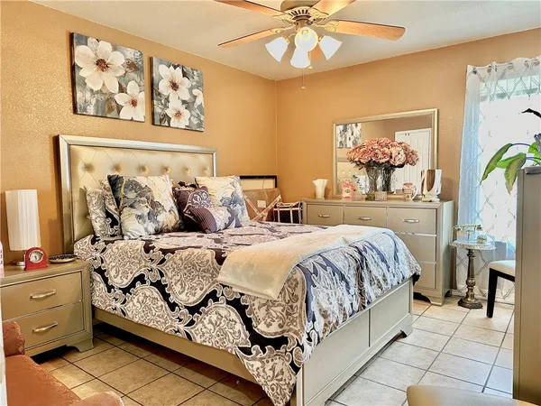 a bedroom with a bed and painting on the wall