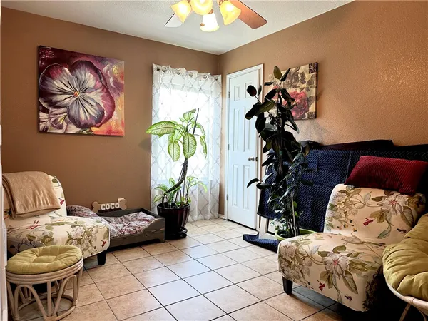 a living room with furniture and flowers