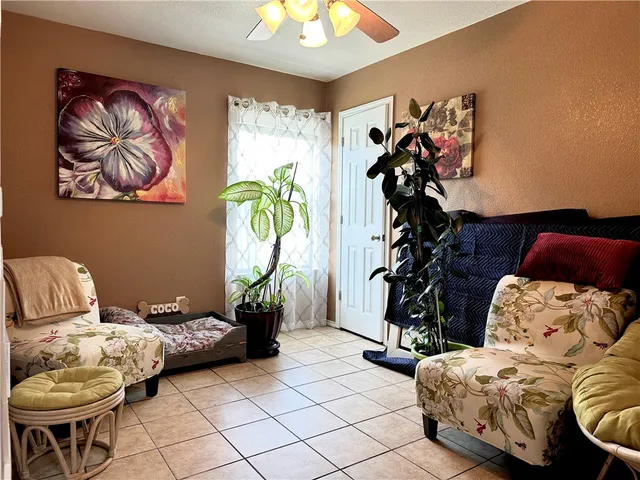 a living room with furniture and flowers