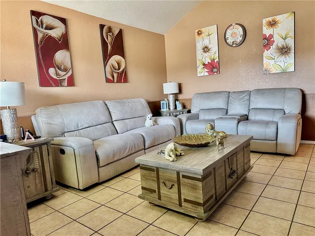 a living room with furniture and a table