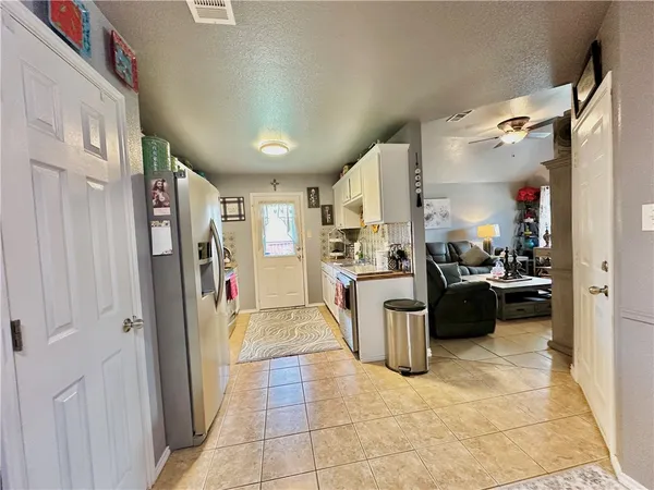 a view of a open kitchen and a sink