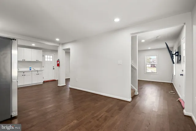 a view of an empty room and wooden floor