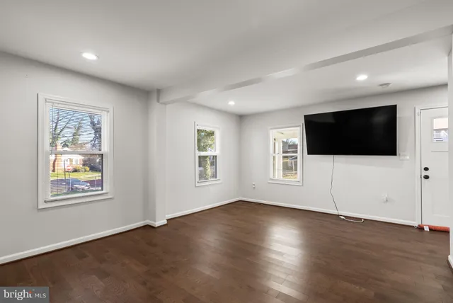 a view of a livingroom with wooden floor and window