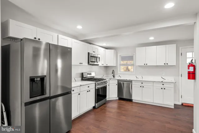 a kitchen with stainless steel appliances granite countertop a refrigerator sink and cabinets