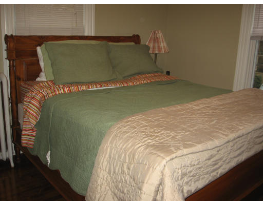 19 Waldorf Road Newton, MA 02461 - Photo 13 of 18 a bed sitting in a bedroom next to a yard