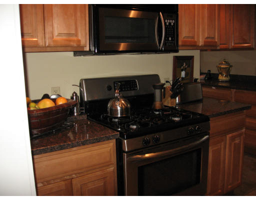 19 Waldorf Road Newton, MA 02461 - Photo 4 of 18 a kitchen with stainless steel appliances granite countertop a stove and a microwave