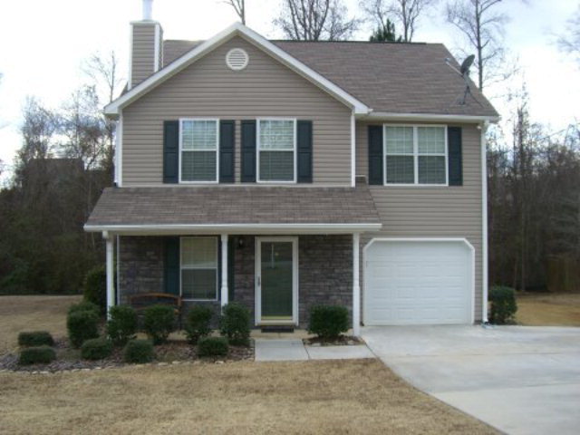 239 Autumn Ridge Court, Unit 14 Gray, GA 31032 - Photo 1 of 1 a front view of a house with garden